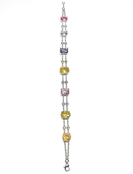 Charming white gold bracelet set with 7 Ceylon sapphires of exceptional and rare natural yellow, green, blue and pink colour for 18 c. approx. intercalated on a double chain of 12 diamonds in closed setting - Gold 8,52 g.