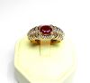 Yellow gold ring set with an oval ruby of good colour weighing 1.10 c. approx. - ring enhanced with baguette and round diamonds for 1 c. approx. - Gold 8.34 g.