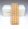 Bracelet with 4 rows of natural cultured pearls salmon color (D: 6 mm) mounted on elastic and decorated with silver patterns