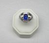 Ring in white gold with a double ring set with 32 baguette diamonds G/VS for 1 c. approx. supporting an oval Ceylon sapphire of very beautiful colour for 2 c. approx. - Gold 5,40 g.