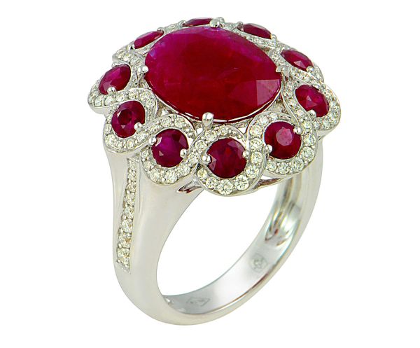 White gold ring set with 4 claws of a natural oval Burmese ruby of intense red color weighing 4.03 c in a surround of round rubies for 2 c approx. interlaced with 112 round modern cut diamonds G/VS - Gold 8.74g. 