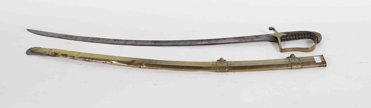 Staff cavalry saber, brass mount, lion head pommel, one branch. Copper fuse, brass filigree. Clover 4 leaves on auricles. Blade with 2 hollow sides engraved on 2 faces. Octagonal brass scabbard with 2 rings. 