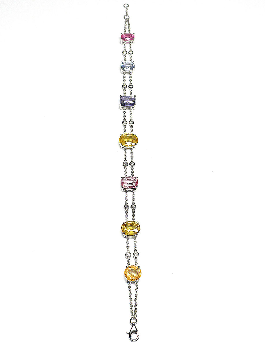 Charming white gold bracelet set with 7 Ceylon sapphires of exceptional and rare natural yellow, green, blue and pink colour for 18 c. approx. intercalated on a double chain of 12 diamonds in closed setting - Gold 8,52 g.